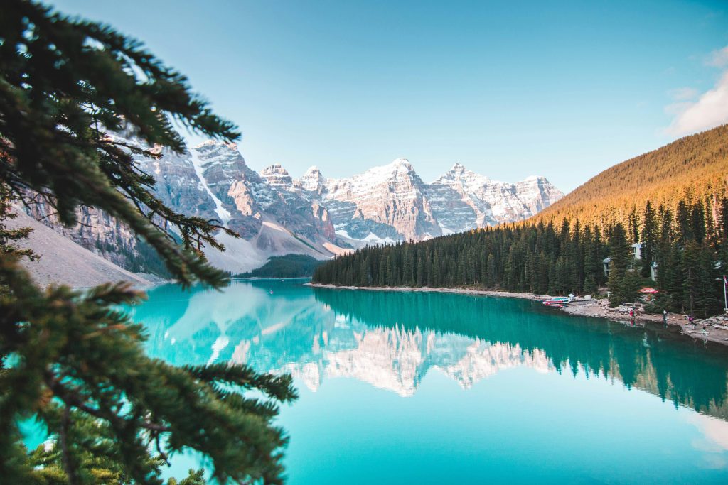 Top 10 Tourist Destinations in India Idyllic view of Moraine Lake reflecting mountains and forests in Banff National Park, Canada.